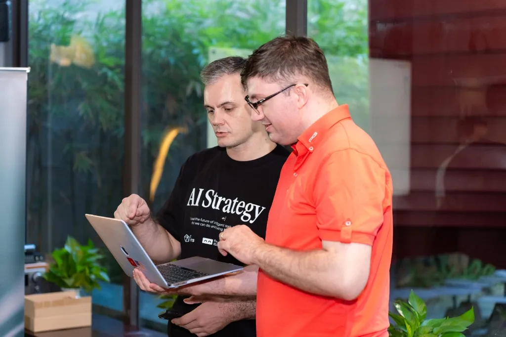 Looking over a laptop with someone at a recent event