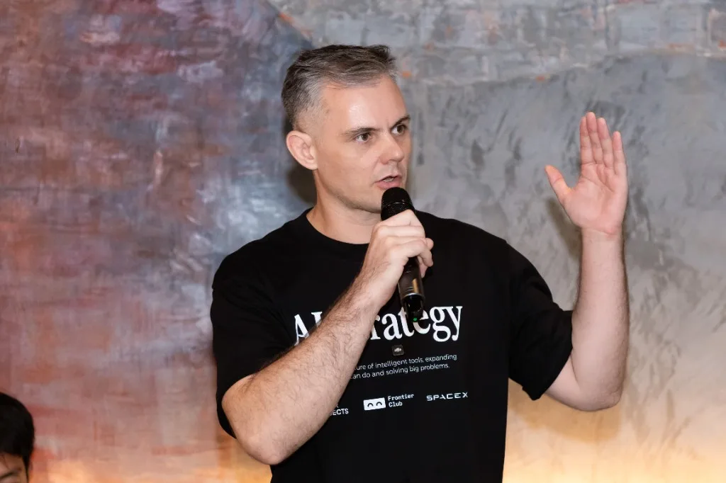 Speaking into a microphone at a recent event, one hand raised